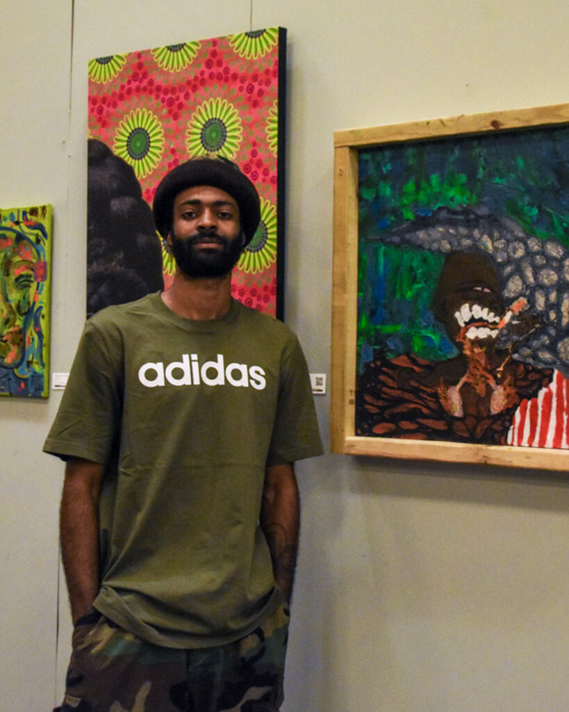 man standing in front of his artwork