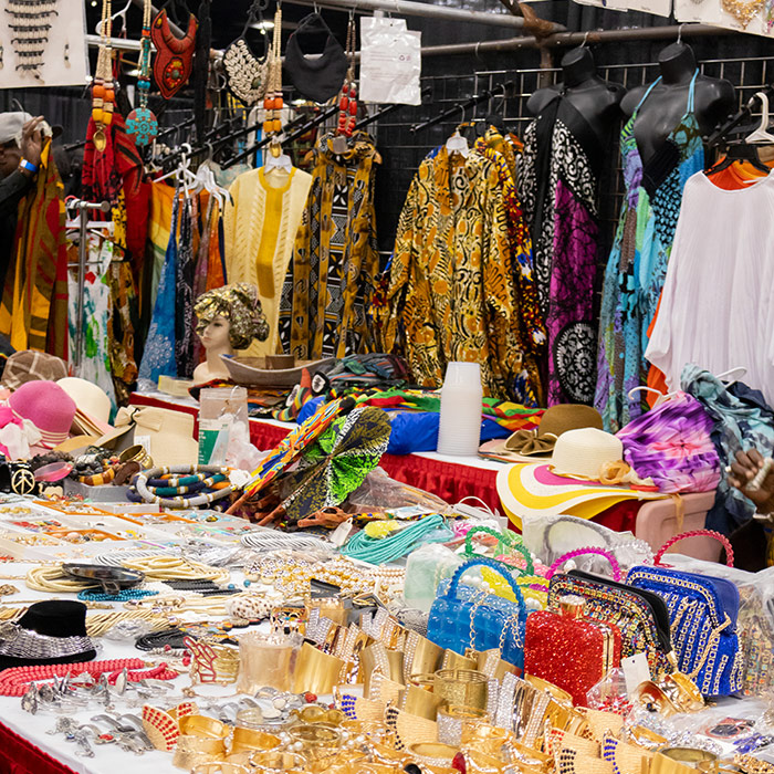 table with jewelry and colorful fabrics in the background